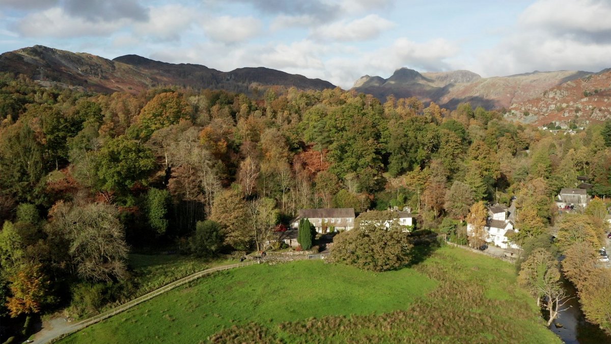 Aerial view of Elterwater Hostel with Langdale Pikes in the background